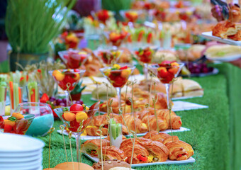 Buffet served table with snacks,fruits,canape,sweets and appetizers.Catering event plate service.Smorgasbord,food choice of breakfast in restaurant