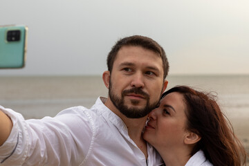 Fototapeta premium young man takes a selfie with his lover