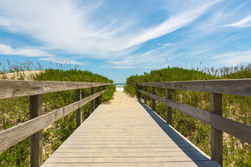 Wooden boardwalk over the dunes to the sea