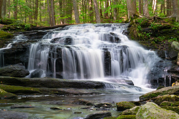 close up on flowing waterfall cascade in the river
