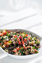 traditional greek Ktapodi octopus salad bowl on Athens restaurant table