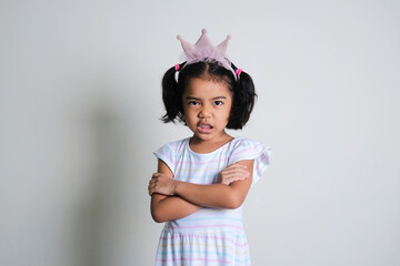 Asian little girl crossed her arms and showing angry face expression