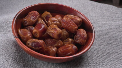 Dates in wooden bowl on background. dried dates fruit.