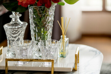 close up herb flower aroma glassware with flower vase set decorate items on white marble table at iving room home interior design concept