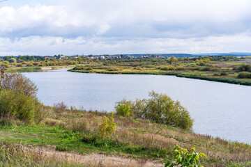 Autumn landscape, river and clouds