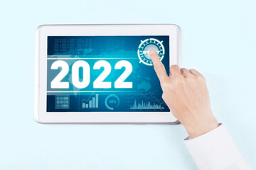 Businessman touches start button for 2022 year