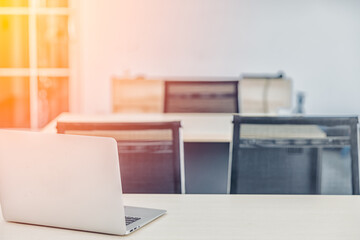 An office room with orange light coming through the window at sunset