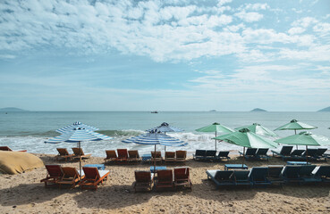 Fototapeta na wymiar Beautiful beach with relaxing chairs