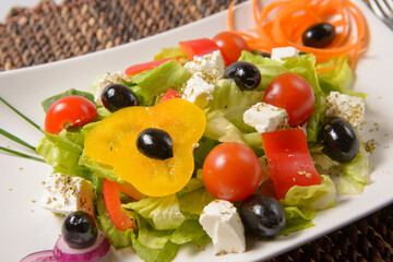 Fresh capresse salad with vegetables, tomatoes, cheese, olives. North American cuisine