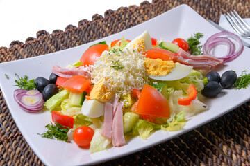 Fresh bulgarian salad with vegetables, tomatoes, onion, olives, boiled eggs, cheese and bacon