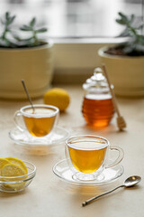 tea drinking in transparent glass dishes