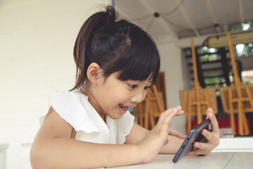 Little girl using smartphone, Social media concept.