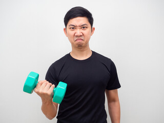 Man feeling confident holding drumbbell up motivation workout