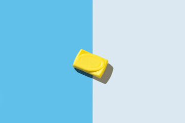 Yellow soap isolation on blue and white background with hard light effect