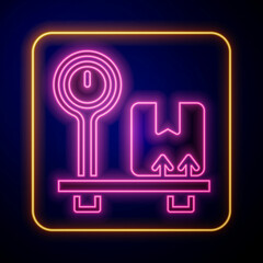 Glowing neon Scale with cardboard box icon isolated on black background. Logistic and delivery. Weight of delivery package on a scale. Vector