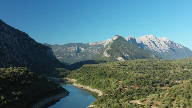 View from above, stunning aerial view of the Cedrino Lake - Lago del Cedrino, surrounded by the mountain range of Supramonte located northeast of the Gennargentu massif. Sardinia, Italy.