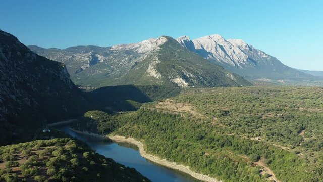 View from above, stunning aerial view of the Cedrino Lake - Lago del Cedrino, surrounded by the mountain range of Supramonte located northeast of the Gennargentu massif. Sardinia, Italy.