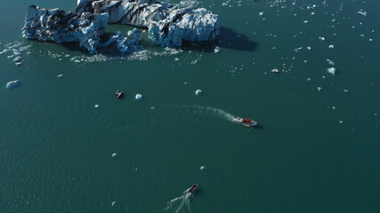 Tourists speed  Boat
at Glacier Lagoon aerial 
drone shot from Jökulsárlón Iceland, September, 2021
