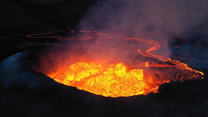 Aerial view over volcanic eruption, Night view, Mount Fagradalsfjall
lava spill out of the crater ...