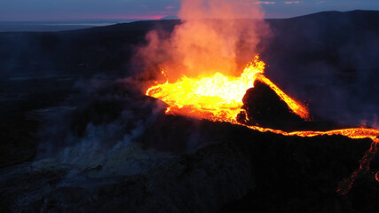 Aerial view over volcanic eruption, Night view, Mount Fagradalsfjall
lava spill out of the crater ...