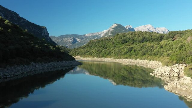 View from above, stunning aerial view of the Cedrino Lake - Lago del Cedrino, surrounded by the mountain range of Supramonte located northeast of the Gennargentu massif. Sardinia, Italy.