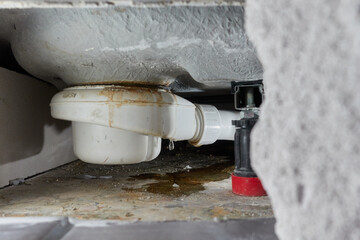 Leaking siphon of a shower tray in the bathroom, causes water damage. Tiles and masonry were...