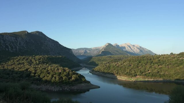 View from above, stunning aerial view of the Cedrino Lake - Lago del Cedrino, surrounded by the mountain range of Supramonte located northeast of the Gennargentu massif. Sardinia, Italy.