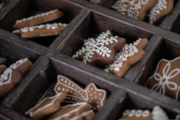 Collection of various gingerbread cookies in a box with fir branches