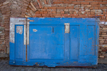 an old and blue door ready for repair in Bistrita, Romania 2021