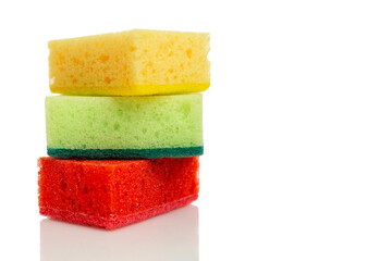 Multi-colored bright sponges for cleaning. Kitchen assistants in the fight for cleanliness. Isolated on white background. Space for text.