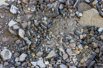 Destroyed asphalt. Broken road surface. Fragments of asphalt pavement.