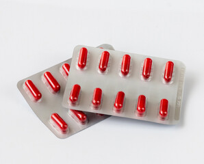 Red capsules in a blister - tabletted medicinal substance