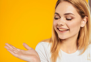 cheerful woman in a white positive posing joy smile yellow background