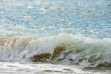 translucent shore break wave in close-up