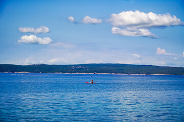 Fototapeta premium seascape, with relaxation on the water swimmer on a surfboard, the Adriatic Sea 