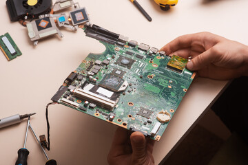 Wizard repairs laptop with tools and hands