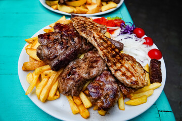grilled meat with fries , meat cutlets Croatian dish, appetizing food on the plate
