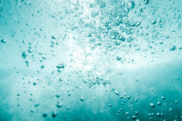 Underwater View of Bubbles In Deep Blue Ocean. Close Up Water. Background