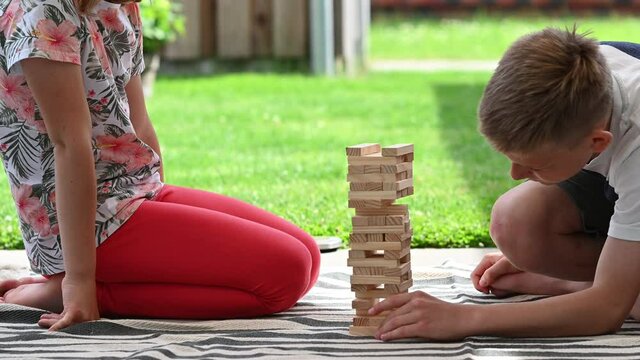 4K 60fps video of two happy children playing with wooden blocks. Having fun together