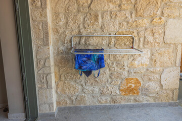 View of outdoor clothes dryer on patio of hotel room.  Greece. 