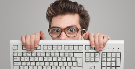 Funny geek man with keyboard - obrazy, fototapety, plakaty