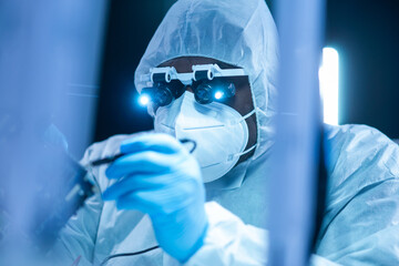 African-American scientist works in a modern scientific laboratory for the research and development of microelectronics and processors. Manufacturing worker uses computer technology and equipment.