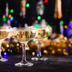 Champagne glasses on a dark background.