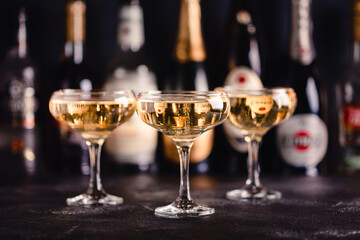 Champagne glasses on a dark background.