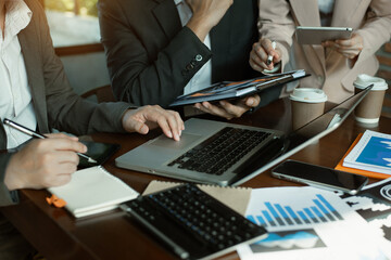 Business team doing paperwork, sitting at cafe on conference. Focused business team learning financial chart, working on corporate project at briefing meeting.