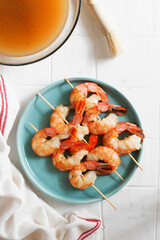 Grilled prawns in the making: lime and green tea on a white background