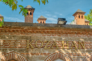 Wall of the ancient koza han (Translation of Kozahan: ancient traditional commercial house) and its wall and blue sky background in Bursa - obrazy, fototapety, plakaty