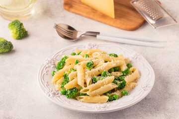 Pasta with green peas, broccoli and parmesan cheese.