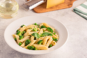 Pasta with green peas, broccoli and parmesan cheese.