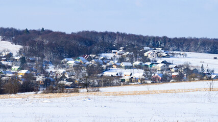 Ukrainian snow-covered villages, panorama of winter and evening villages.